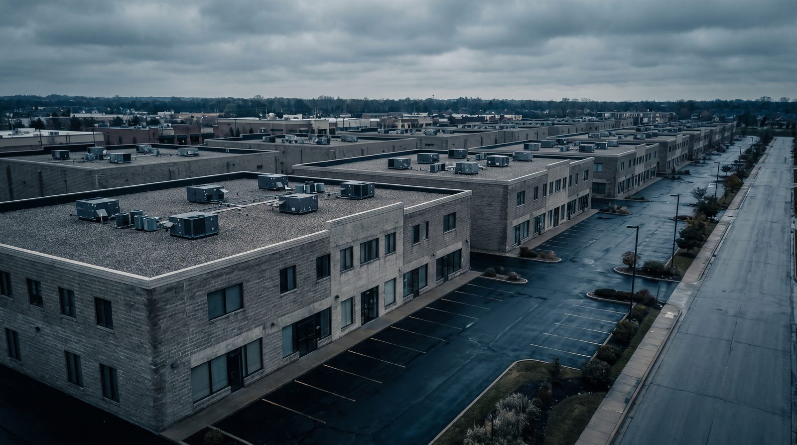 Row of low rise commercial buildings with rooftop mechanical units